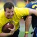 A member of the Maize team carries the ball during the Victors Classic alumni football game at Michigan Stadium on Saturday. Melanie Maxwell I AnnArbor.com